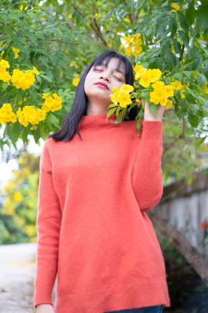 Happy young girl under the beautiful tree.の写真素材