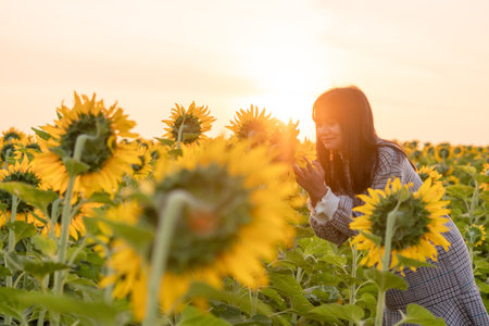 The girl with sunflower at flower park.の写真素材