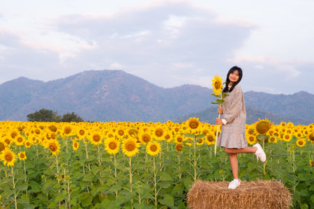Happy young girl with flower.の写真素材