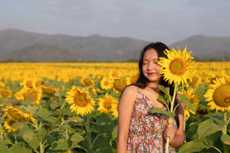 Beautiful young girl enjoy time at the field flowers.の写真素材