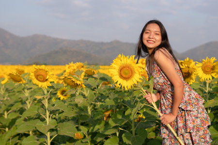 Beautiful young girl enjoy time at the field flowers.の写真素材