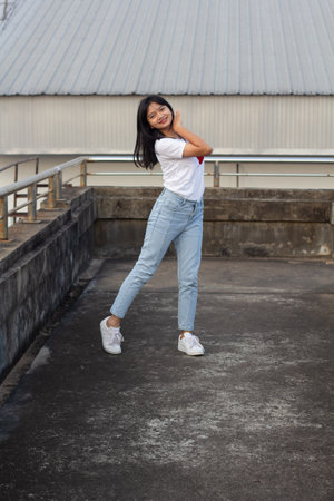 Cheerful young girl dance on over pass.の写真素材