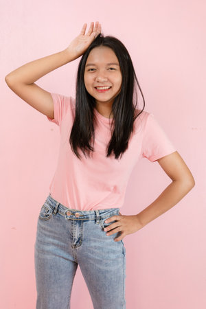 Beautiful young girl smiling standing on pink background.の写真素材