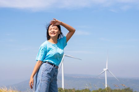 Freedom young girl with blue sky and Wind Turbine,happy concept.の写真素材