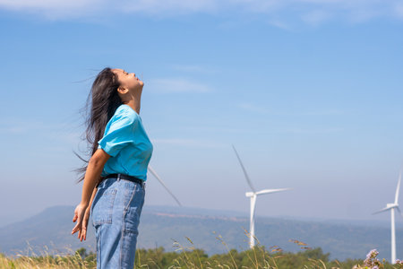 Freedom young girl with blue sky and Wind Turbine,happy concept.の写真素材