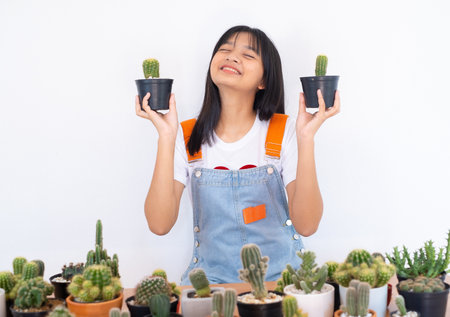 Happy smiling girl with cactus.の写真素材