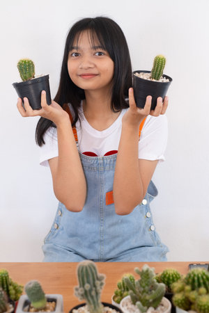 Happy smiling girl with cactus.の写真素材