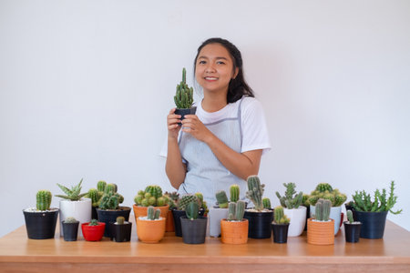 Happy smiling girl with cactus.の写真素材