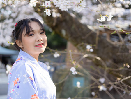 Beautifull tourist girl, happy with cherry blossom at Gokoku Shrine in Kyoto Japan.の写真素材