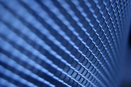 A gridded texture toned blue with a limited depth of focusの写真素材