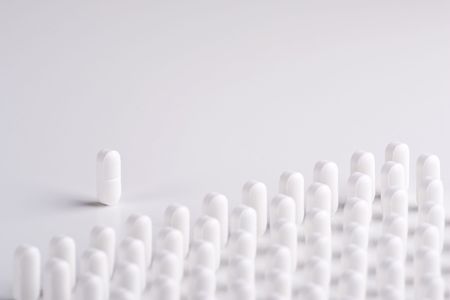 A Pill leader addresses lines of white pillsの写真素材