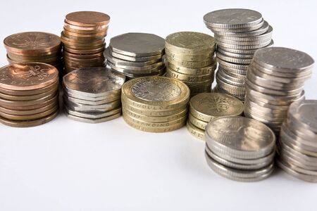 Random piles of used UK coins with copy spaceの写真素材