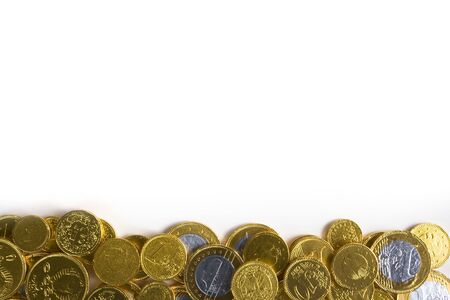 Chocolate money arranged on the bottom of a white frameの写真素材