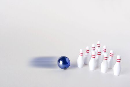 A miniture bowiling ball approaches 10 miniture pins - Inculdes blur and copy spaceの写真素材