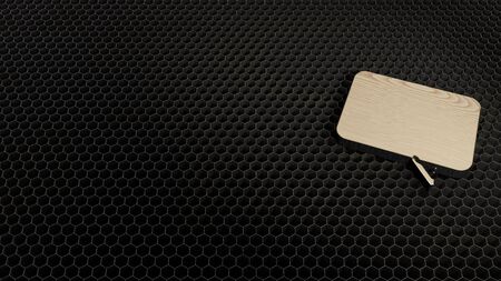 laser cut plywood 3d symbol of rectangular chat bubble render on metal honeycomb inside laser engraving machine backgroundの写真素材