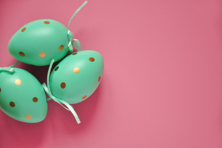 Easter eggs are white blue polka dots. Festive mood. Easter attributes. Easter food. Drawing on the eggs. White pink blue easter backgroundの写真素材