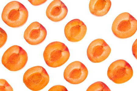 Slices of fresh juicy apricot on a white background. Orange fruit for jam. Sweet vegan healthy food. A lot of apricots.の写真素材
