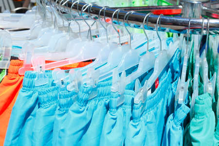 Swim Trunks on a clothes railの写真素材