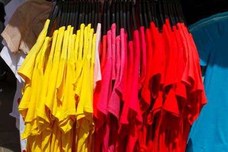 T-shirts on a clothes railの写真素材