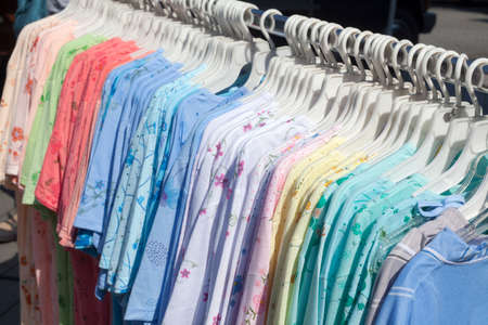 T-shirts on a clothes railの写真素材