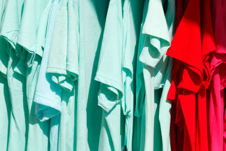 Colorful shirts on a clothes railの写真素材