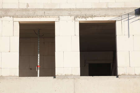white bricks and window holes on a construction siteの写真素材