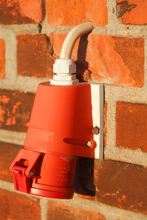 red plug on a red wall