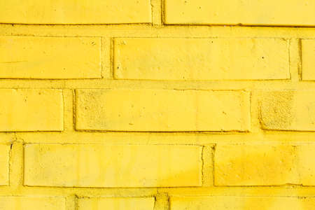 Yellow painted brick wallの写真素材