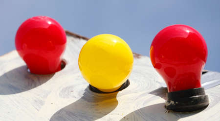 colorfully electric light bulbs with blue skyの写真素材