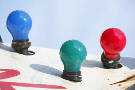 colorfully electric light bulbs with blue skyの写真素材