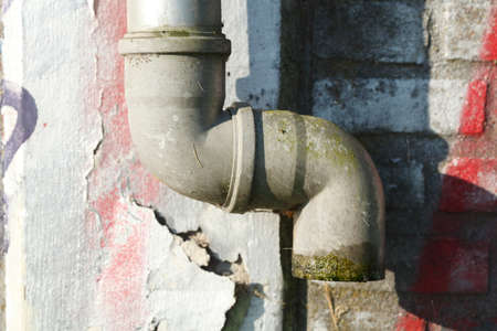 old metal water pipe at a house wallの写真素材