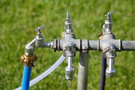 silver metal outside water taps with multiple connectionの写真素材
