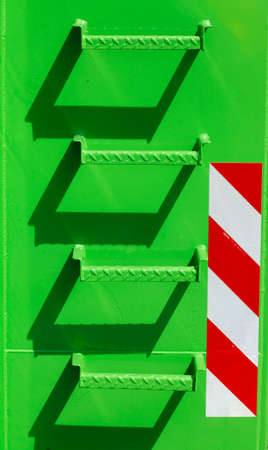 green metal steps on a green metal wall