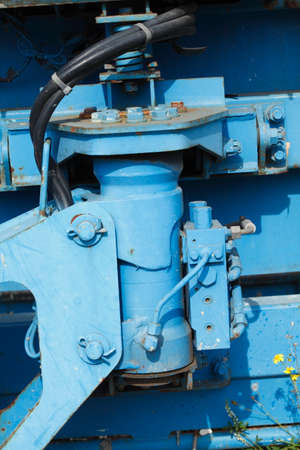 Blue hydraulic cylinder from a construction vehicle