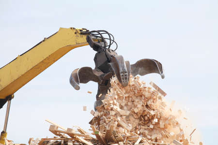 Wooden Garbage, old wooden boards with an Excavatorの写真素材