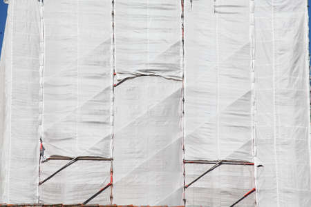 white tarpaulin on a house wall, construction siteの写真素材