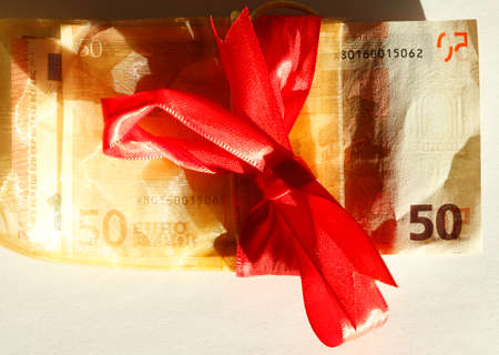 Fifty Euros Banknote with red loop as gift of moneyの写真素材