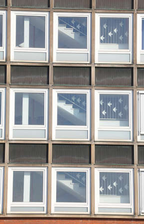 white window front with stairwell on a modern office building