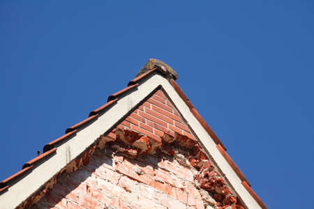 Old House roof gable with Windows from brickの写真素材