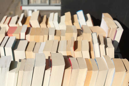 old Paperbacks in a bookshelf of a bookstoreの写真素材