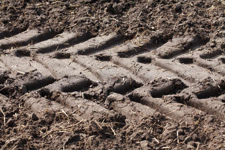 Plowed field fertilized with slurry and tire tracks, Lower Saxony, Germanyの写真素材