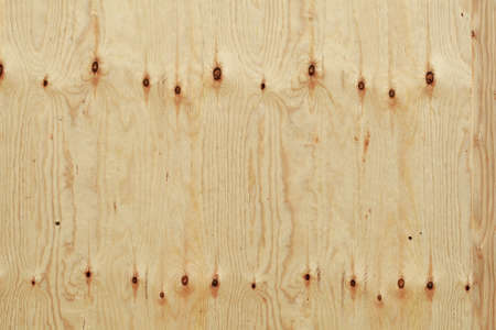 brown wooden wall on a construction fence with knotholesの写真素材