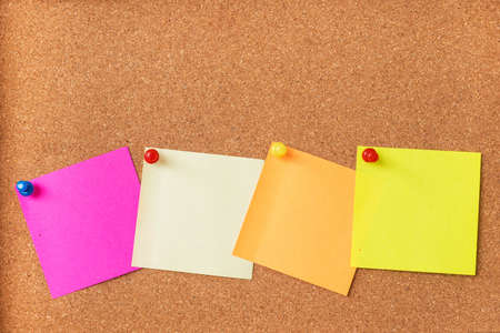 Colorful sticky notes on cork boardの写真素材