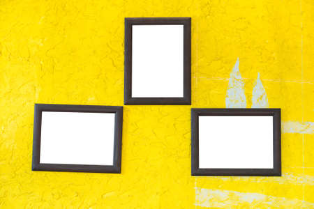 Wooden photo frames on vintage wallの写真素材