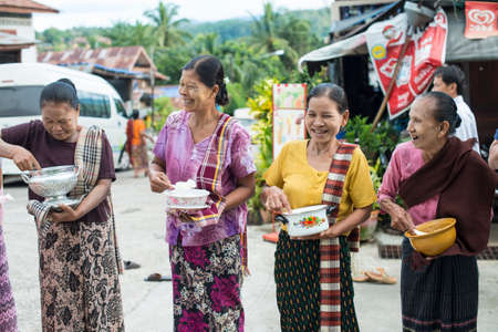 SANGKLABURI - OCT 18   Thai people waiting to donate food to the monks in Sankaburi,Thailand on...