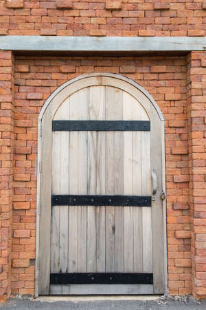Wooden door on the brick wallの写真素材