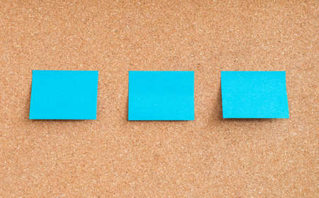 Blue sticky notes on cork board の写真素材