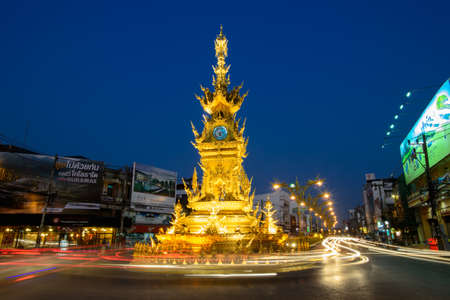 CHIANG RAI - JAN 2   Light trails on street around golden clock tower, established in 2008 by Thai visual artist Chalermchai Kositpipatat, at night on January 2, 2014 in Chiang Rai, Thailand  のeditorial素材