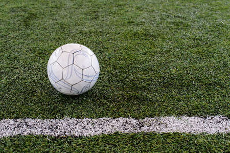 Soccer ball on green fieldの写真素材