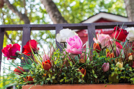 Artificial flowers in the basket in vintage themeの写真素材